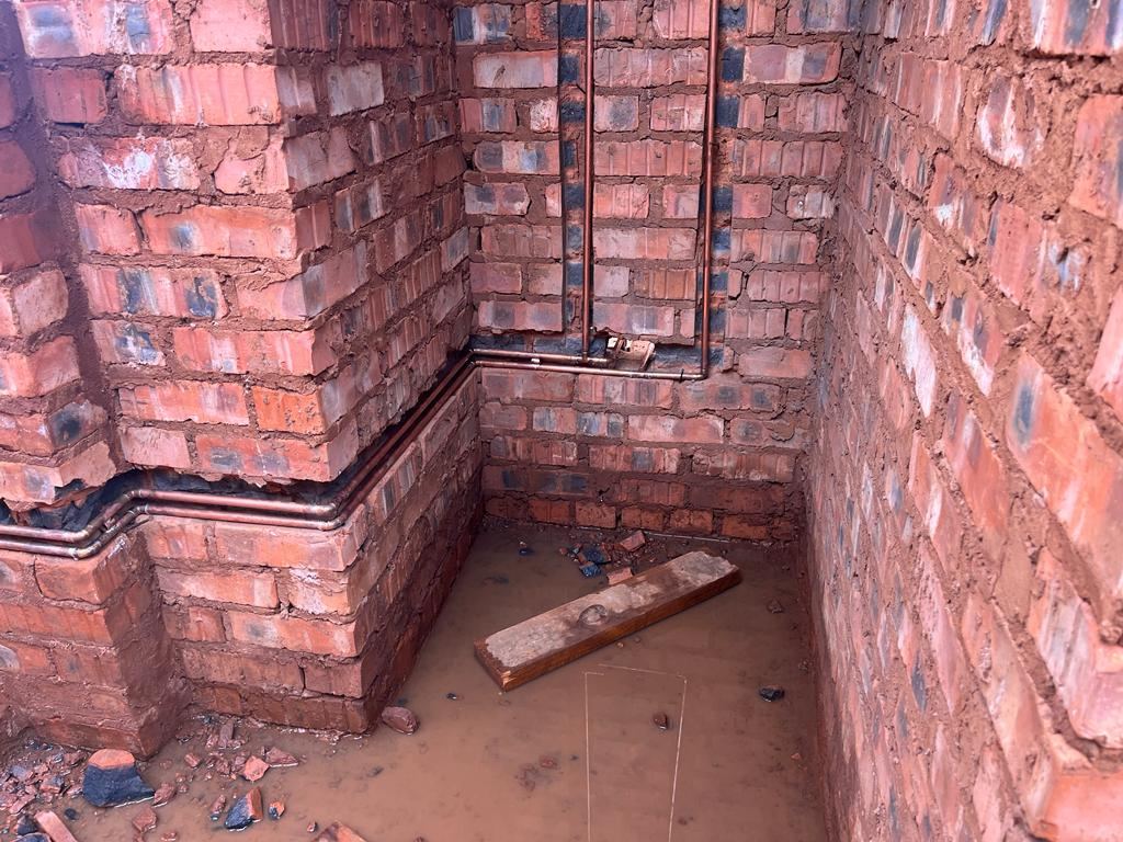 Copper first-fix pipework on brickwork during construction