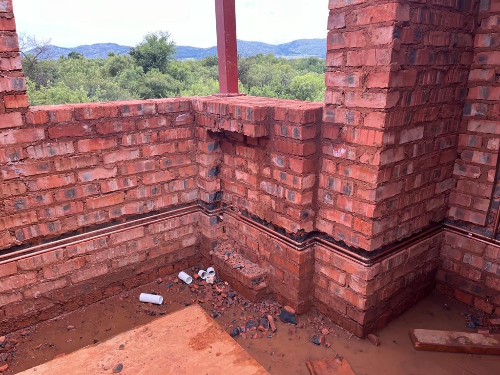 Copper supply lines installed along brick walls of a new build
