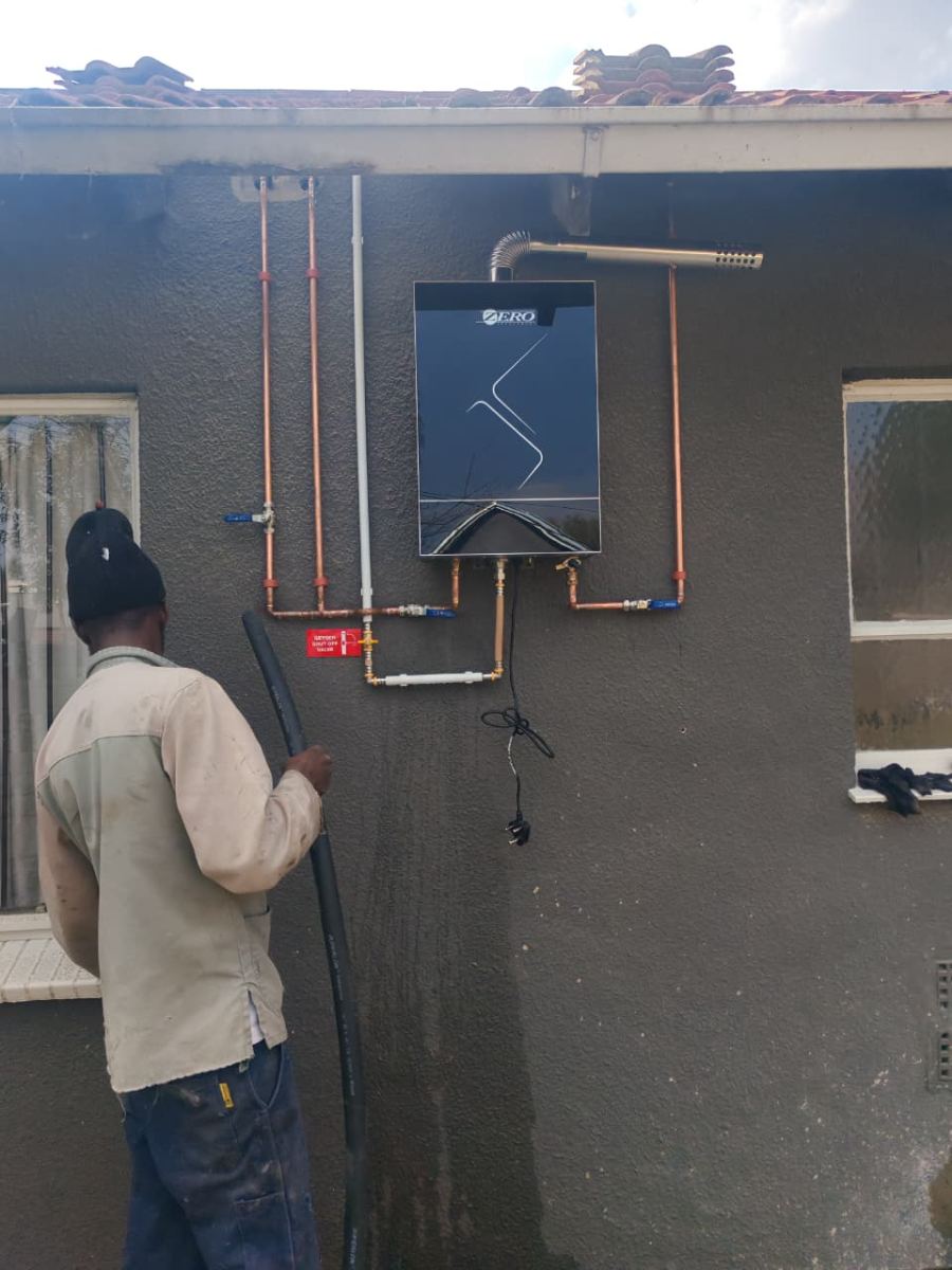 Completed gas geyser installation with shut-off valve and flue