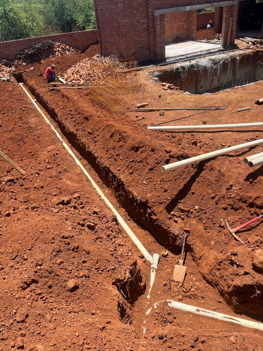 Drainage pipework laid in a trench alongside a new building